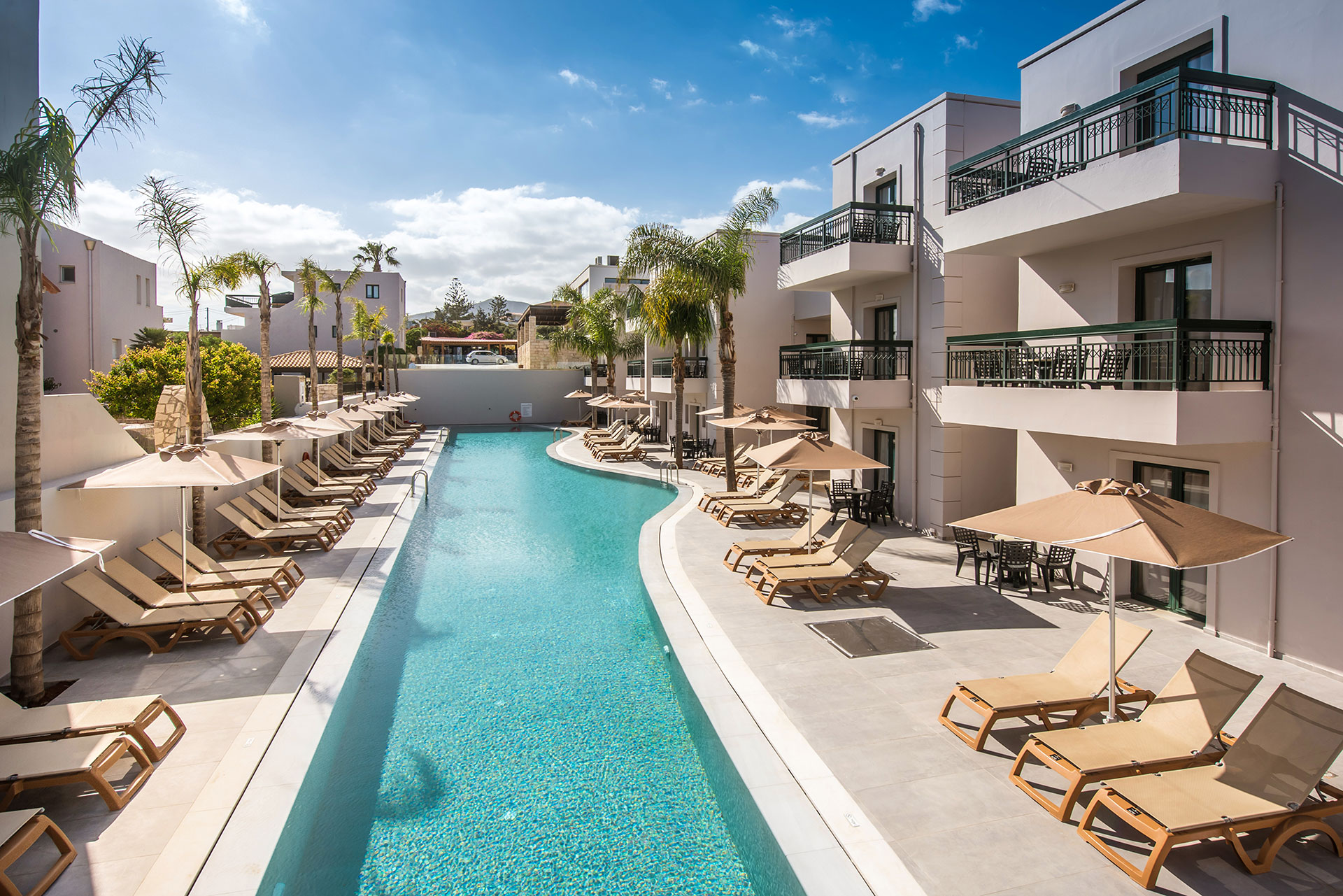 Gouves Park entire length of the pool with sunbeds and umbrellas alongside it