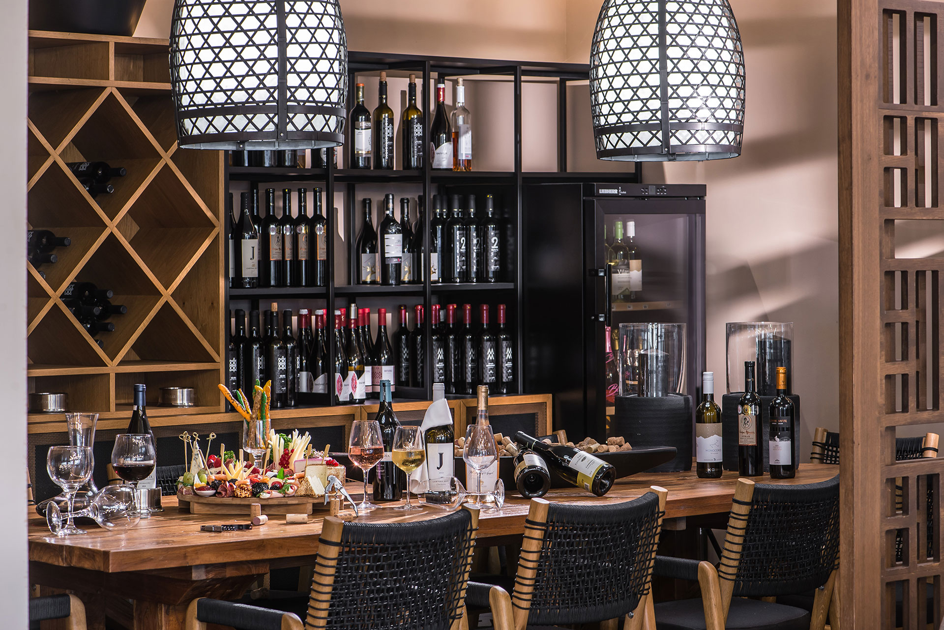 Gouves Park Umami Asian Restaurant big table full of wine bottles and the wine cellar in the background