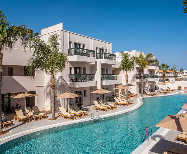 Gouves Park view of the pool with sunbeds, umbrellas and the hotel in the background