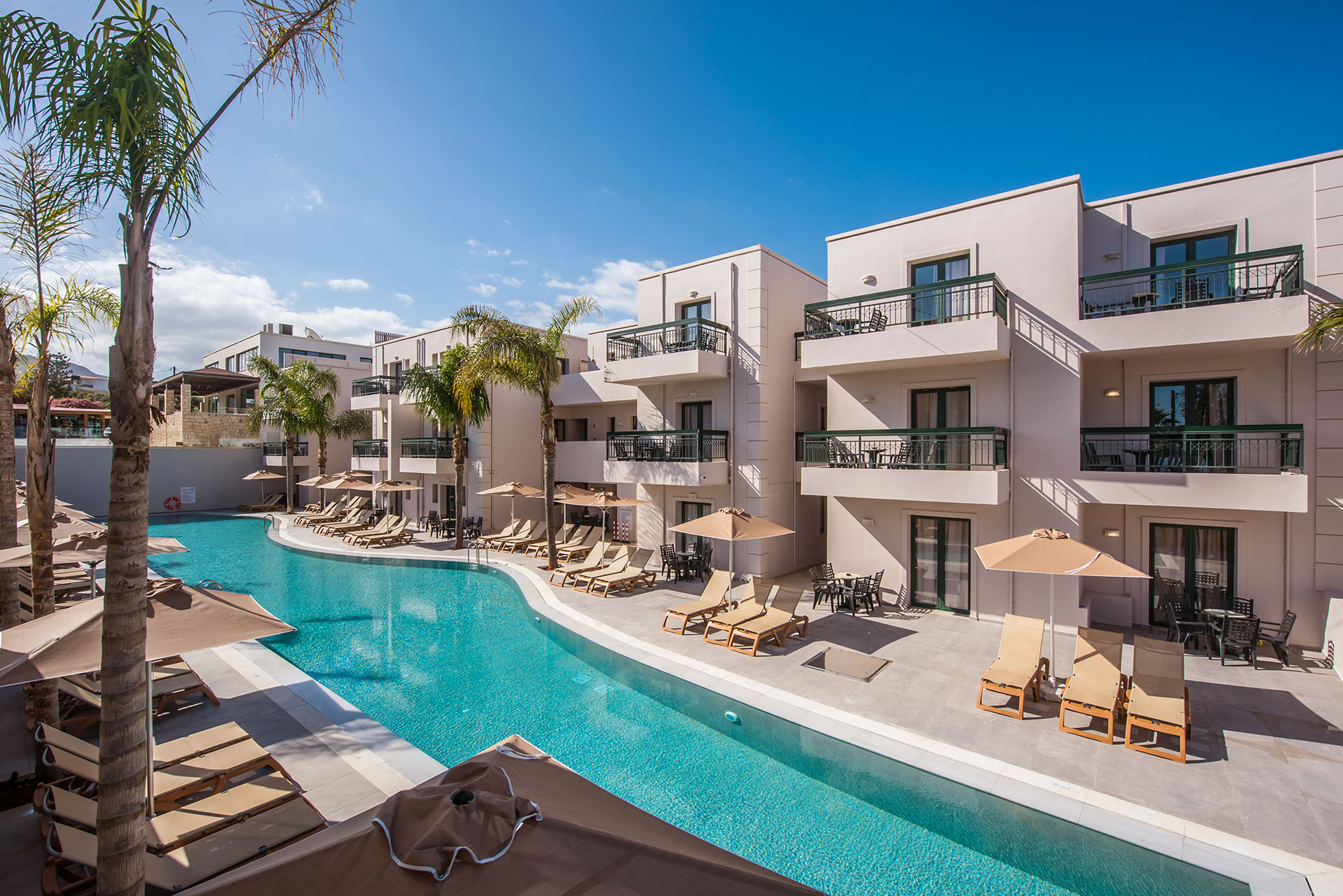Gouves Park long pool with sunbeds and umbrellas alongside it and the hotel in the background