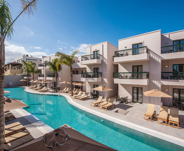 Gouves Park long pool with sunbeds and umbrellas alongside it and the hotel in the background