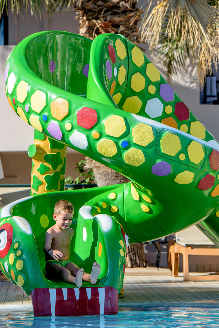 Gouves Park Mini Water Park child sliding through the snake water slide