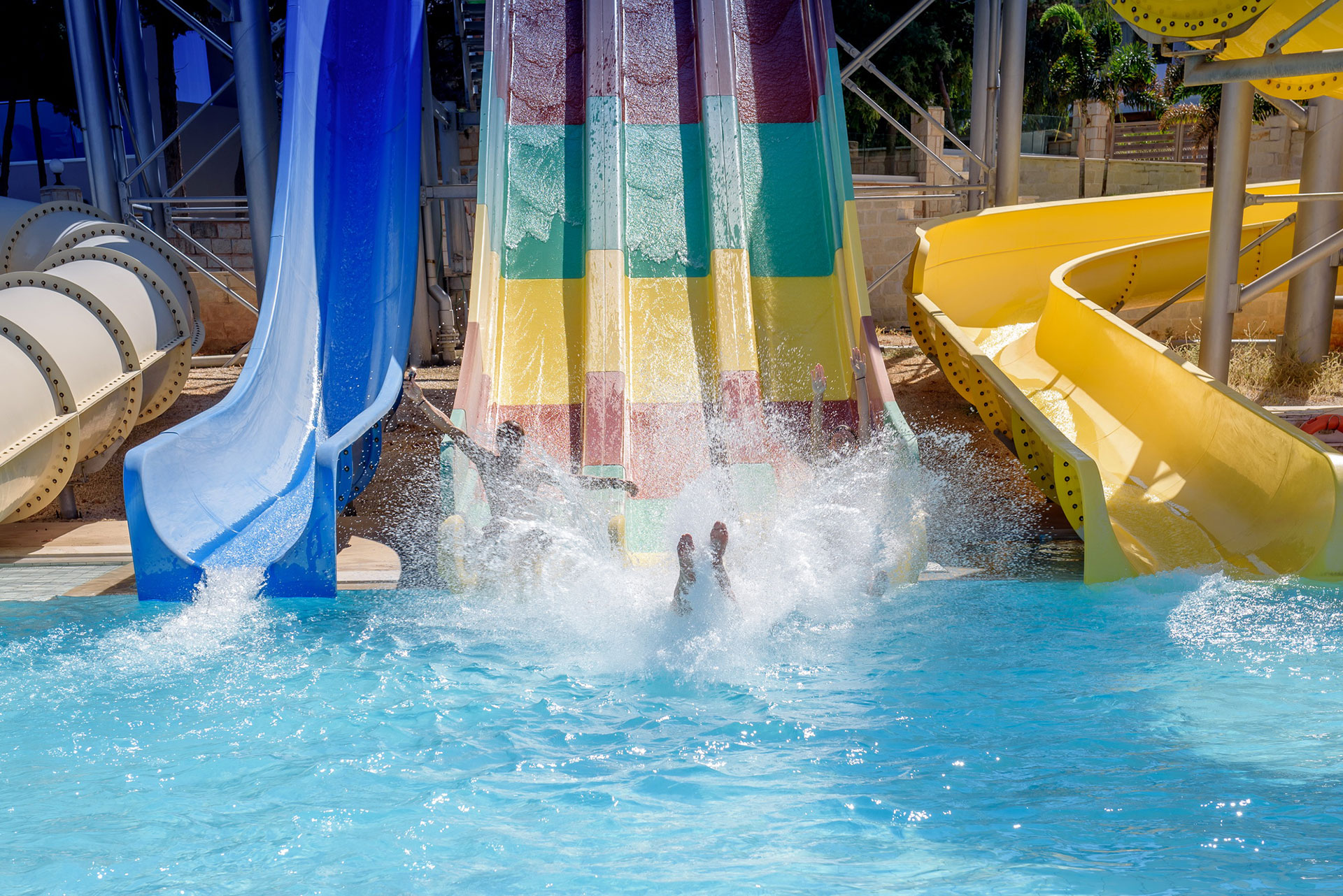Gouves Park Slides Park visitor sliding in the pool from the waterslide
