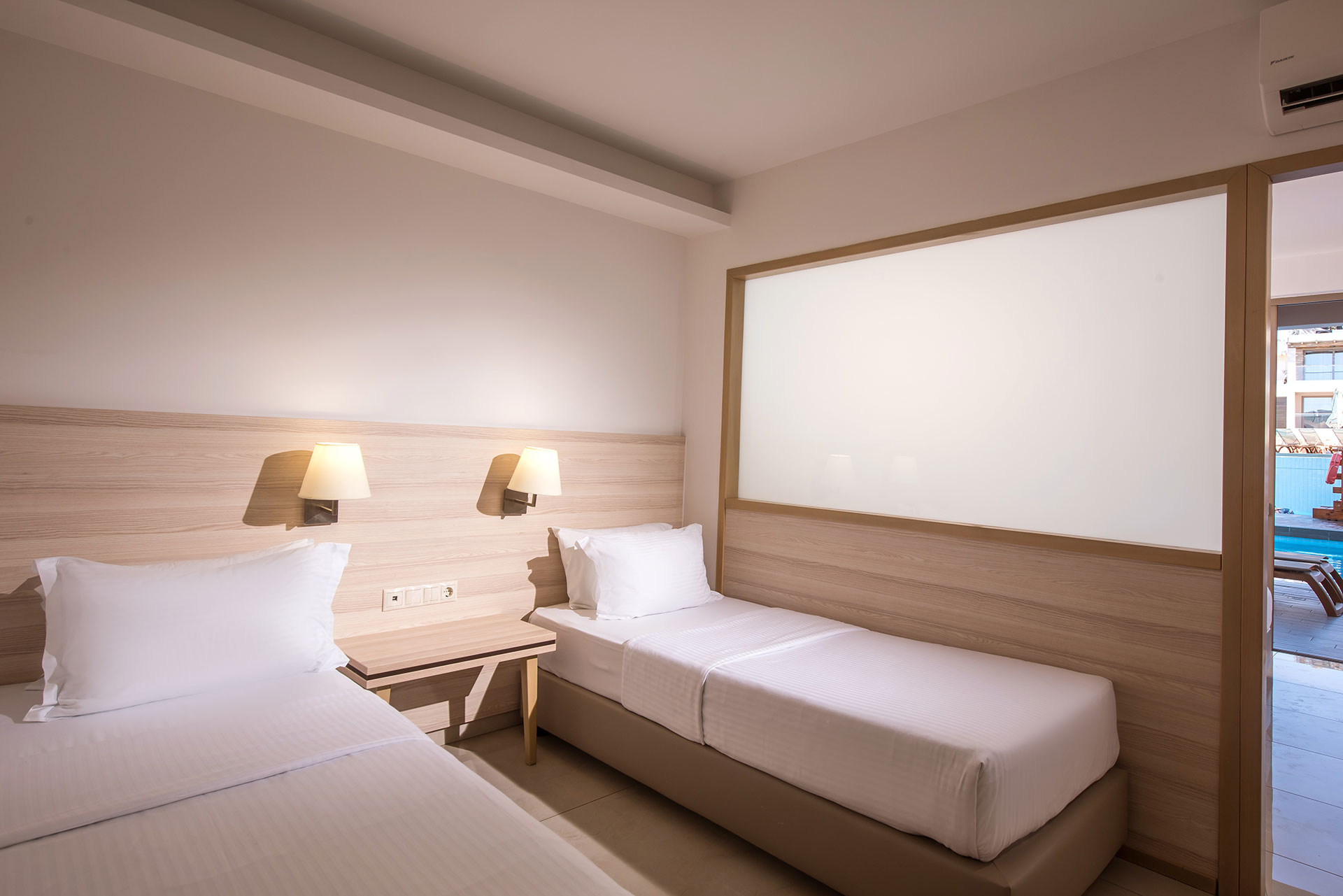 Gouves Park Family Suite Swim Up two single beds, bedside table and amenities