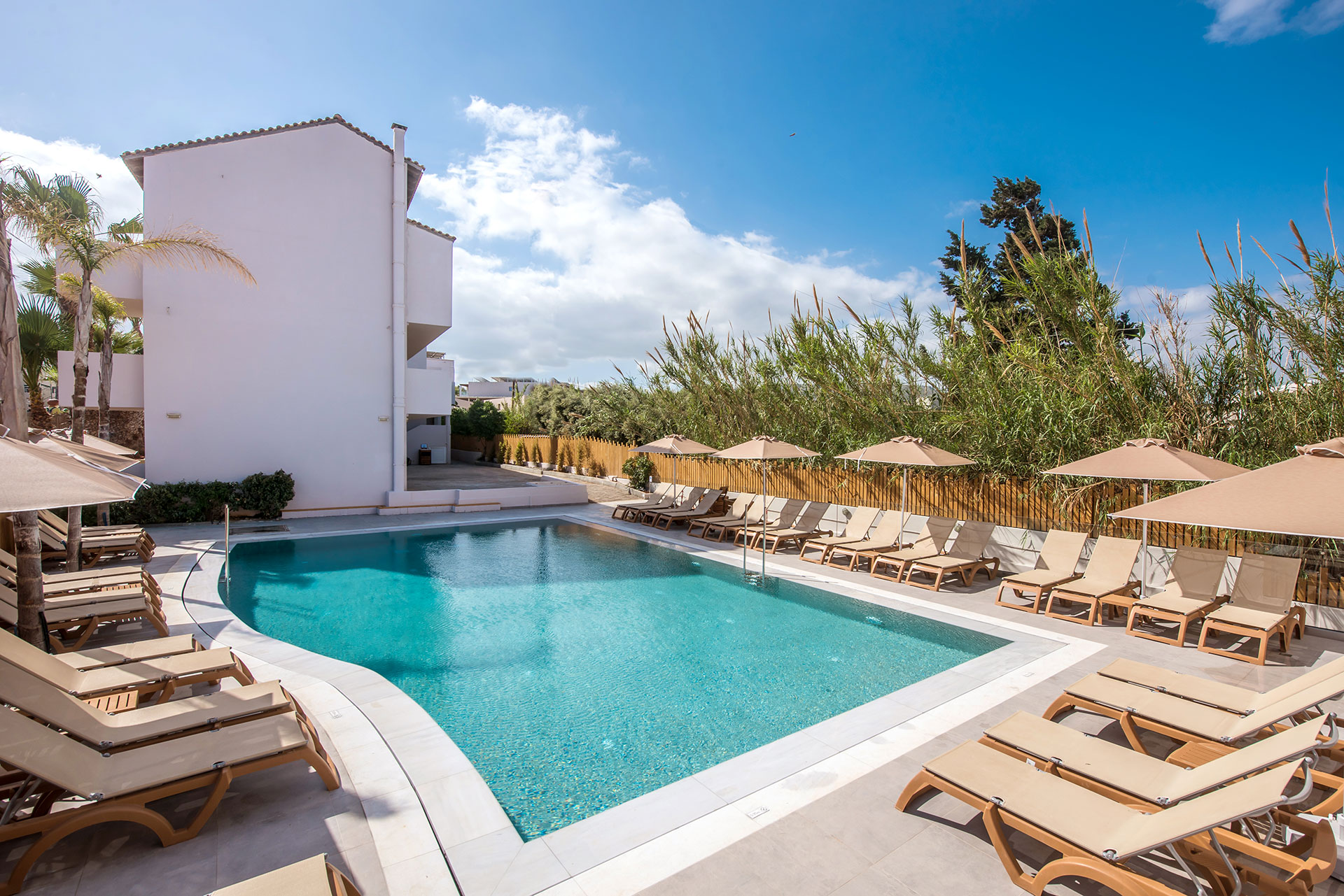Gouves Park small pool with sunbeds and umbrellas at the side and the hotel in the background