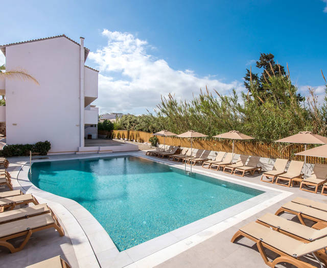 Gouves Park small pool with sunbeds and umbrellas at the side and the hotel in the background