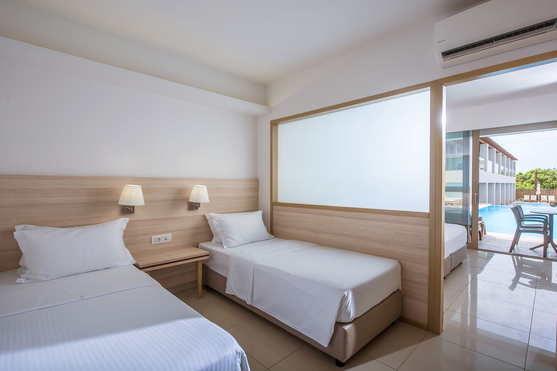 Gouves Park Family Suite Swim Up two single beds, bedside table and amenities