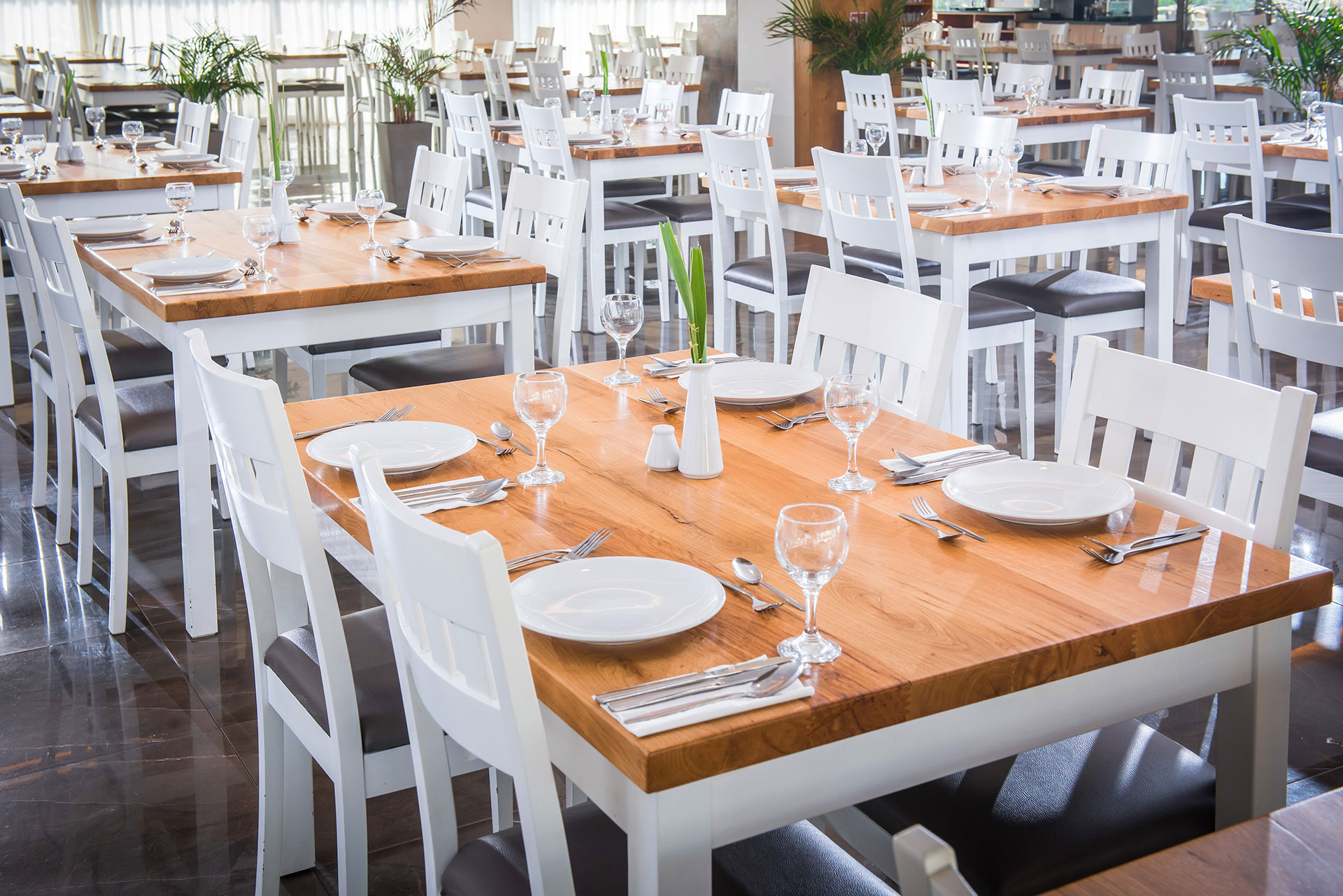 Gouves Park Dionysos Restaurant tables decorated with plates, glasses and cutlery