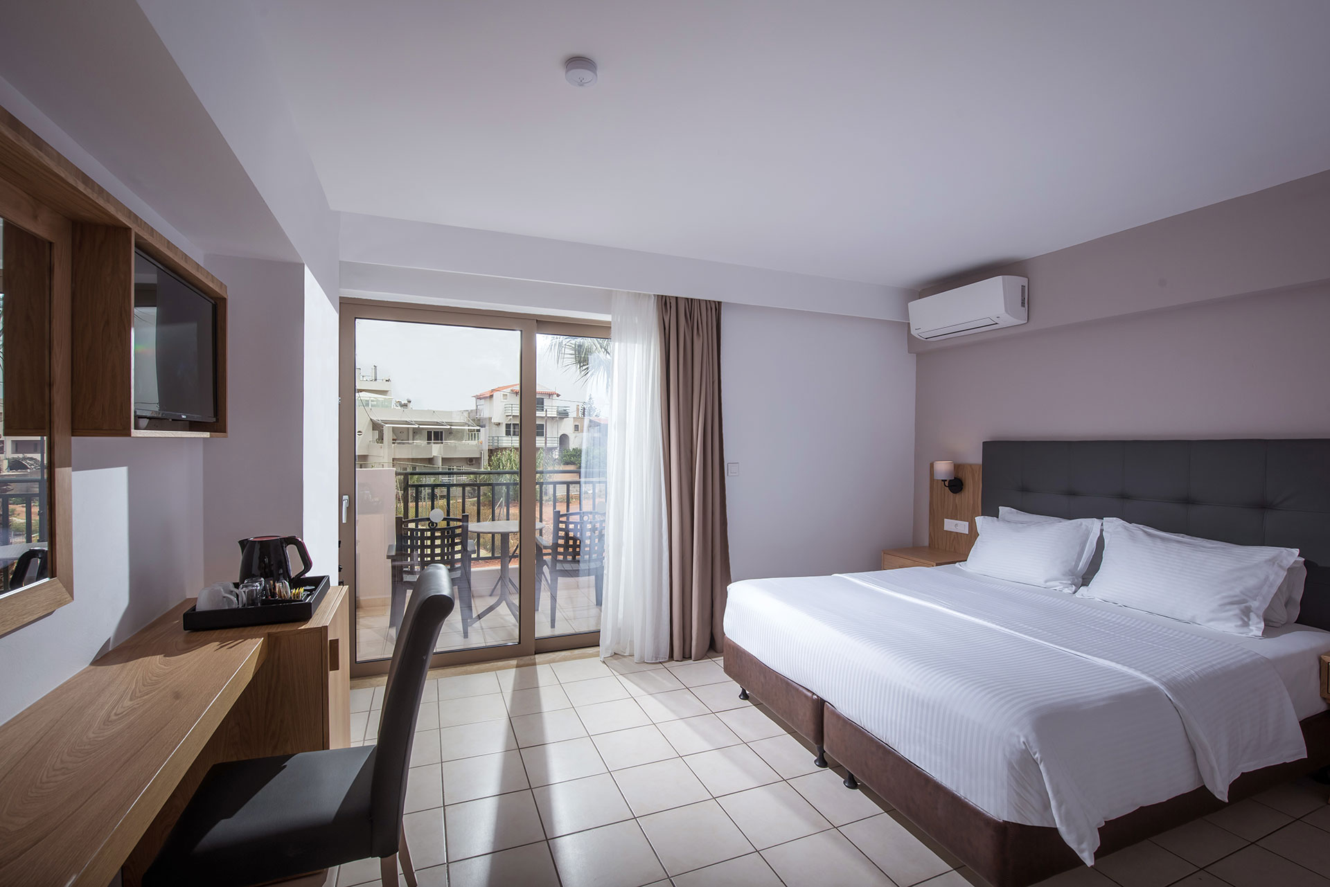 Gouves Park Double Room with double bed, a big wooden counter, balcony view and amenities