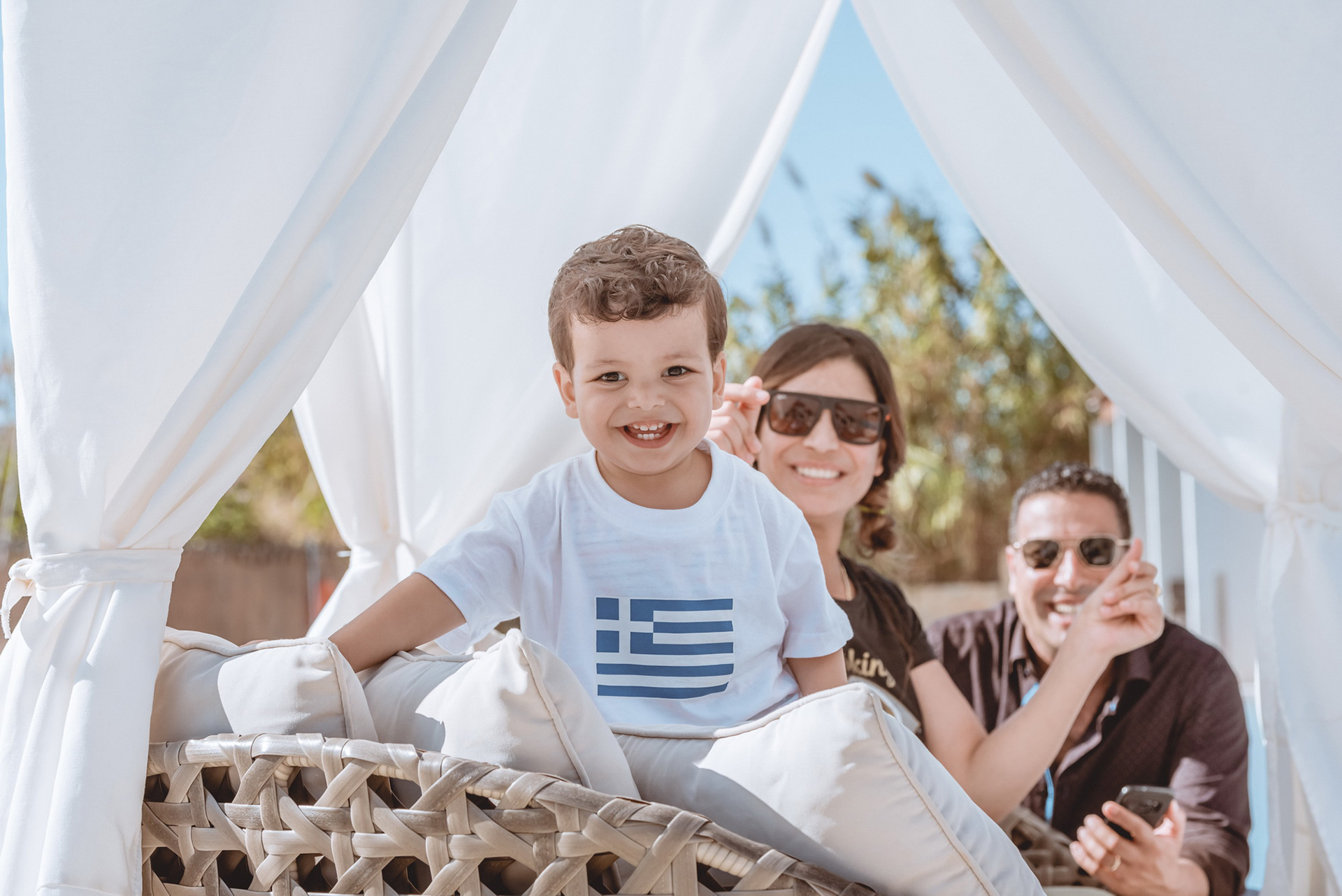 Happy family portrait with smiling child and parents at Gouves Water Park Holiday Resort