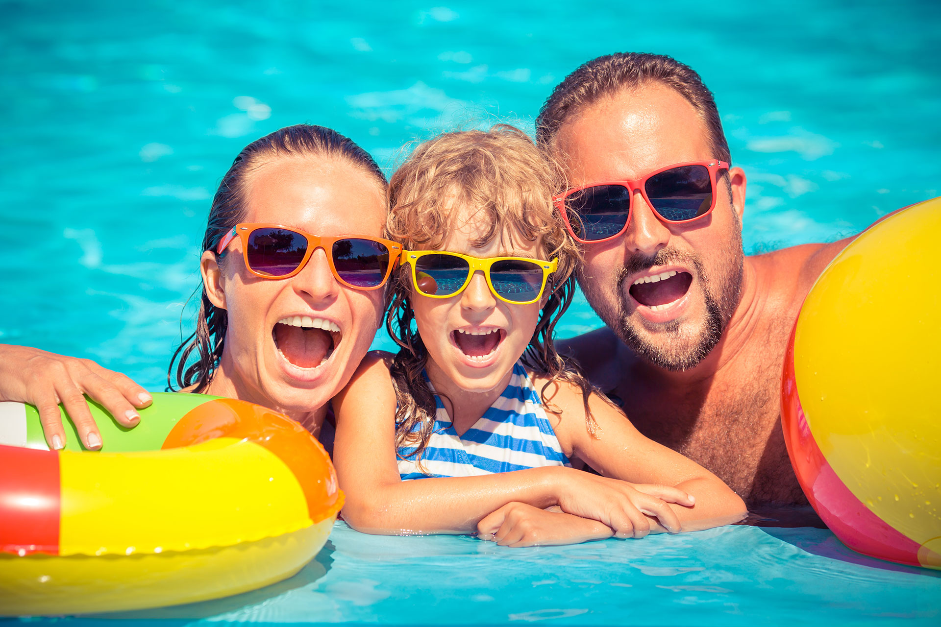 Gouves Park family posing for a photo while in the pool