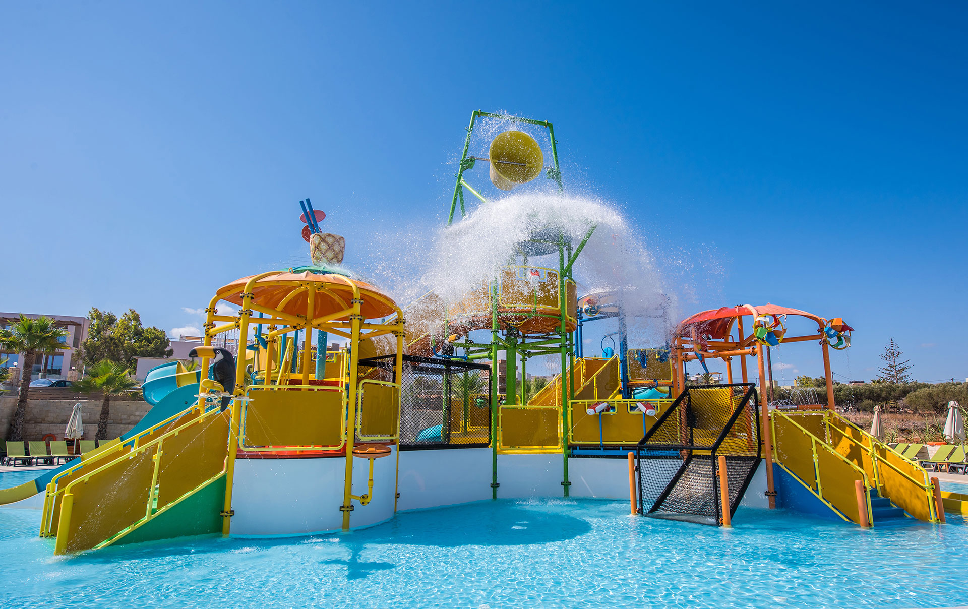 Gouves Park Splash Water Park slides being splashed with water from a big bucket