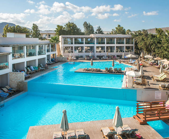 Gouves Park large pool of two levels with sunbeds and umbrellas in the side