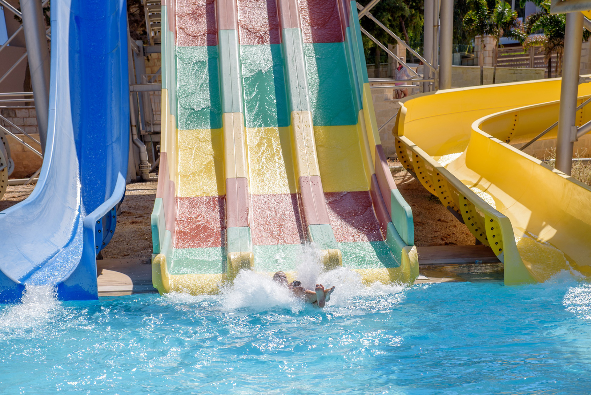 Gouves Park Slides Park visitor sliding in the pool from the waterslide