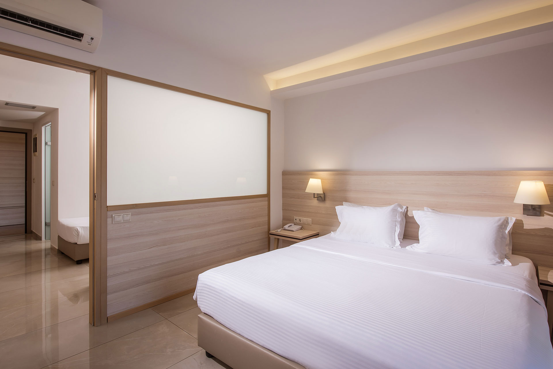 Gouves Park Family Suite bedroom with one double bed, two beside tables and amenities