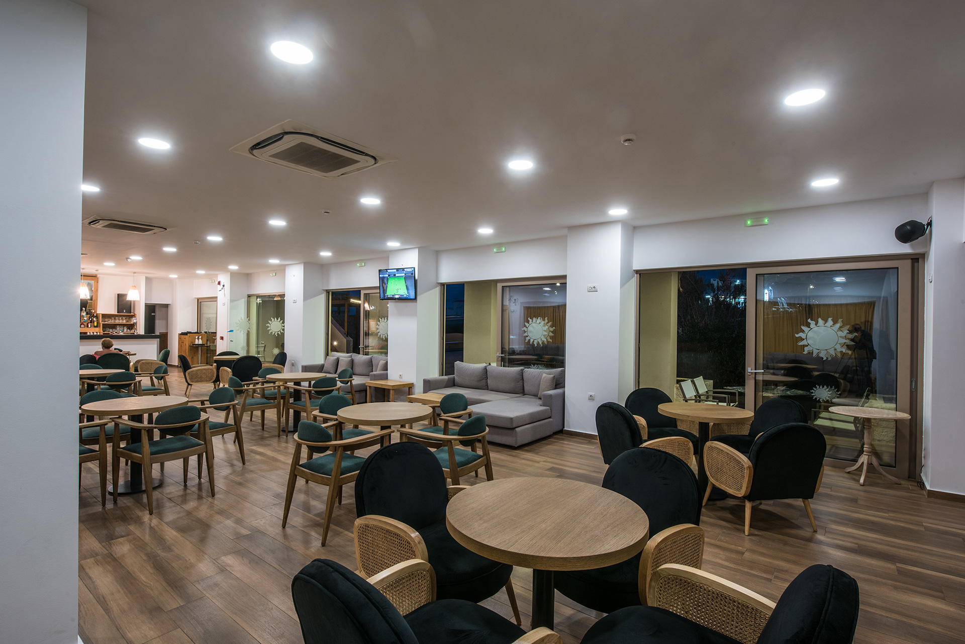 Gouves Park Zeus Bar indoor sitting area with round tables, chairs and couches